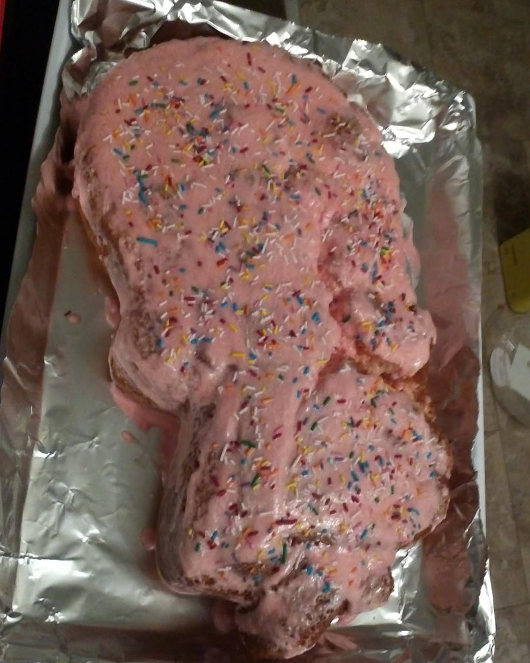  Another pink cake covered in sparkles.  It's held together a little more nicely, but there is still a clear chasm in the middle that the icing is doing a bad job of hiding.